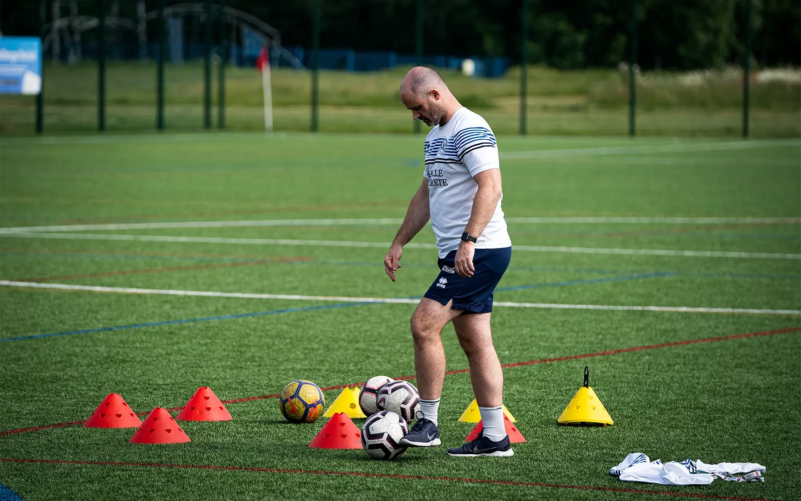 Shot of the coach packing up football equipment
