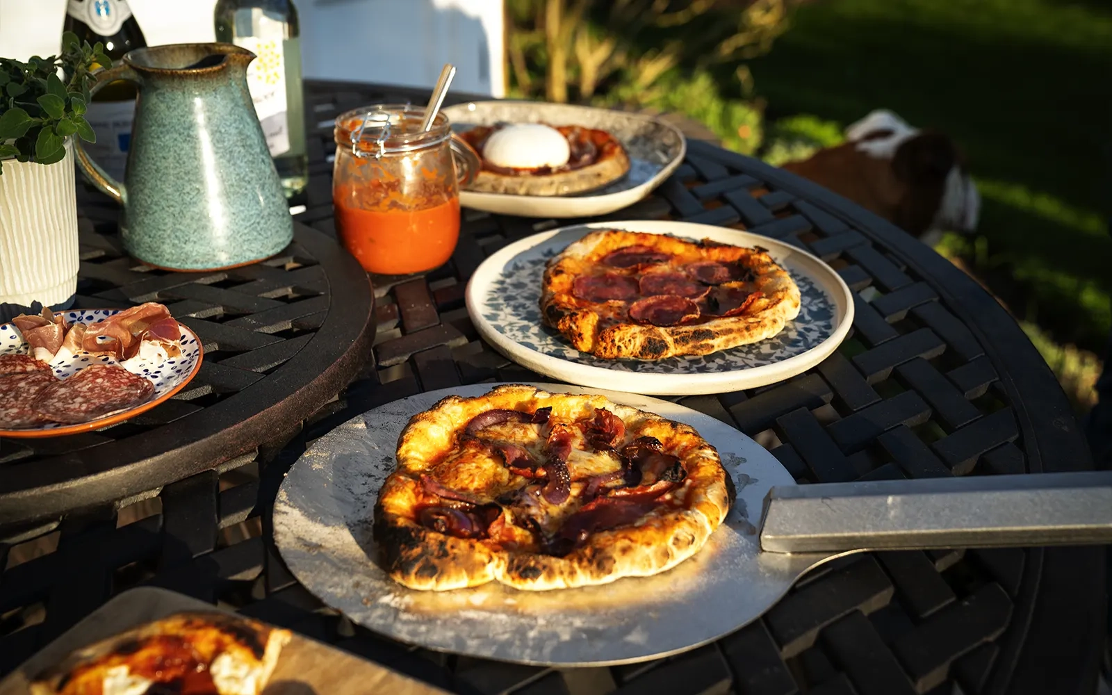 Close-up of several pizzas on an outdoor table