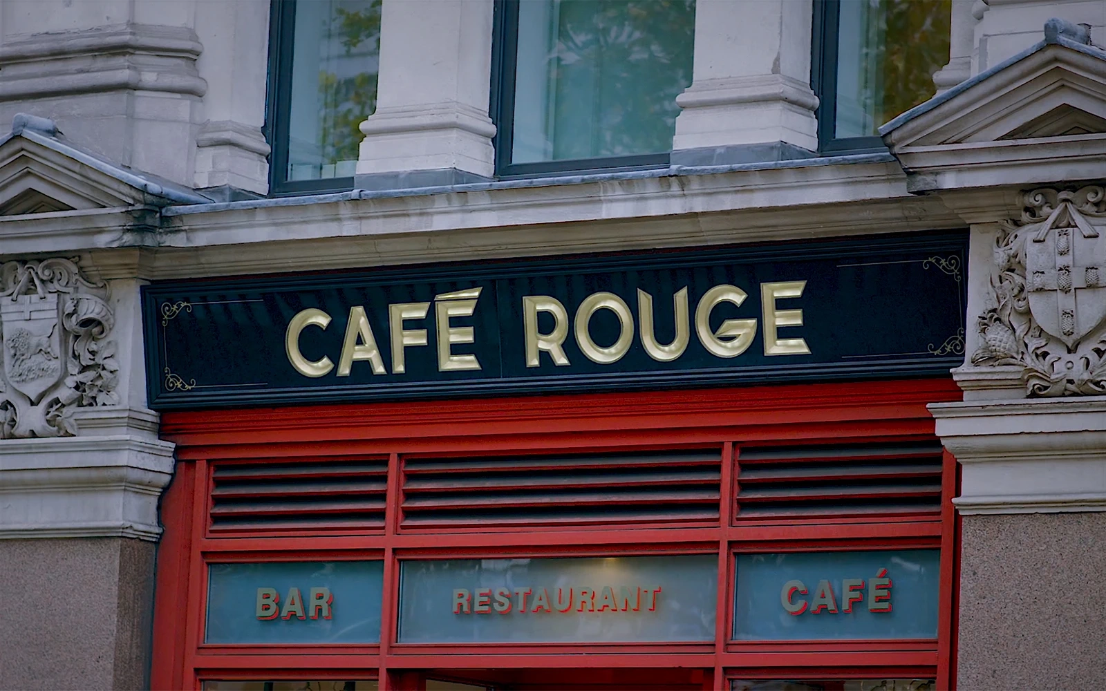 A still from a promotional video showing the Cafe Rouge logo above the entrance of it’s St Paul’s restaurant