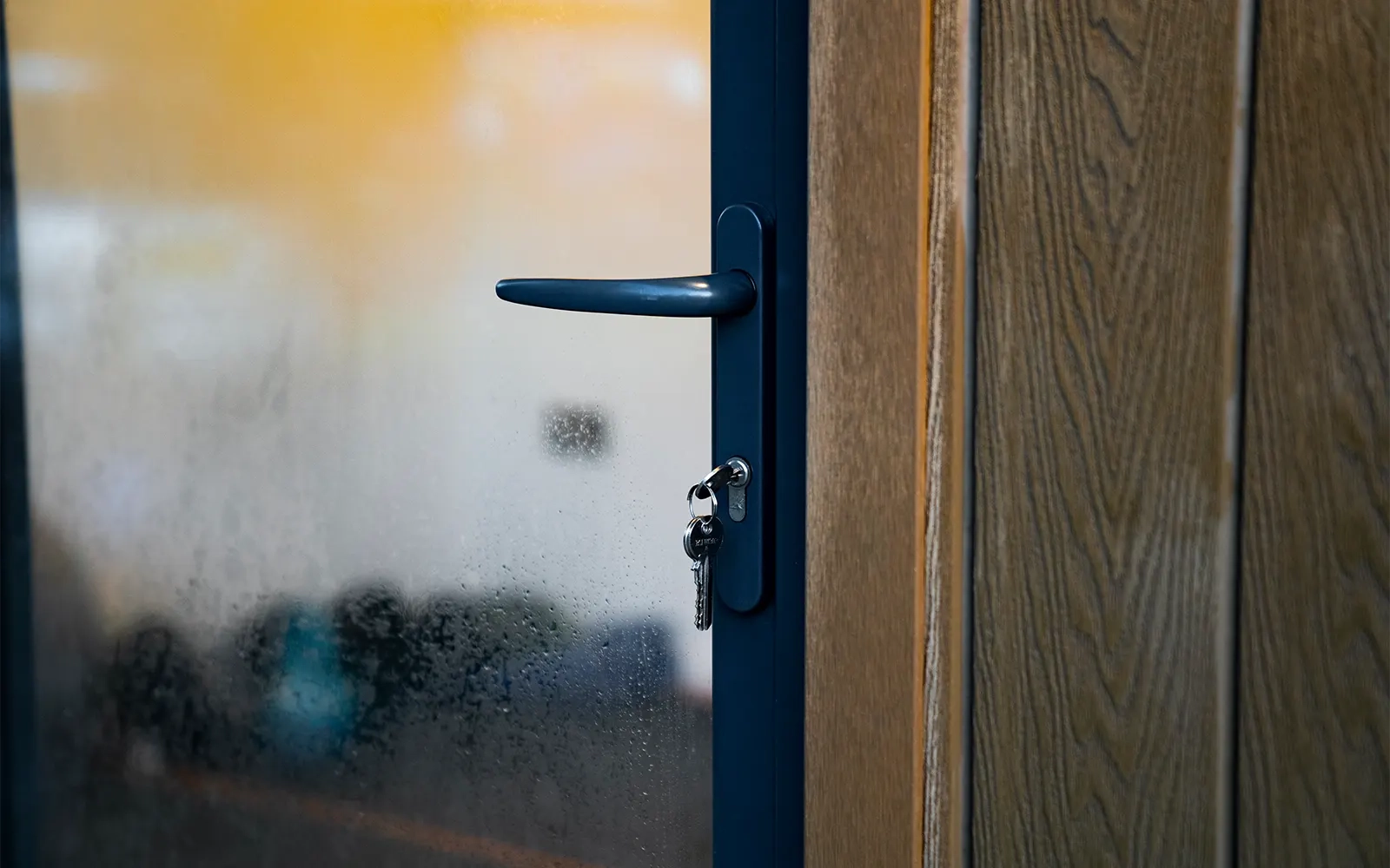 A close-up of the garden room door with the keys in the lock